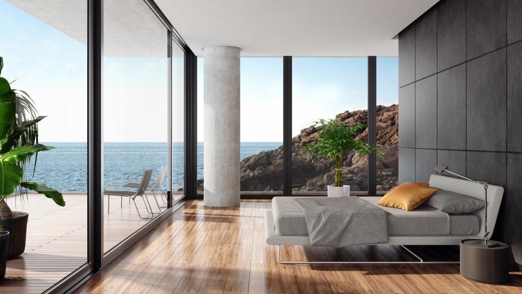 Modern luxurious bedroom in a seaside villa with black stone wall