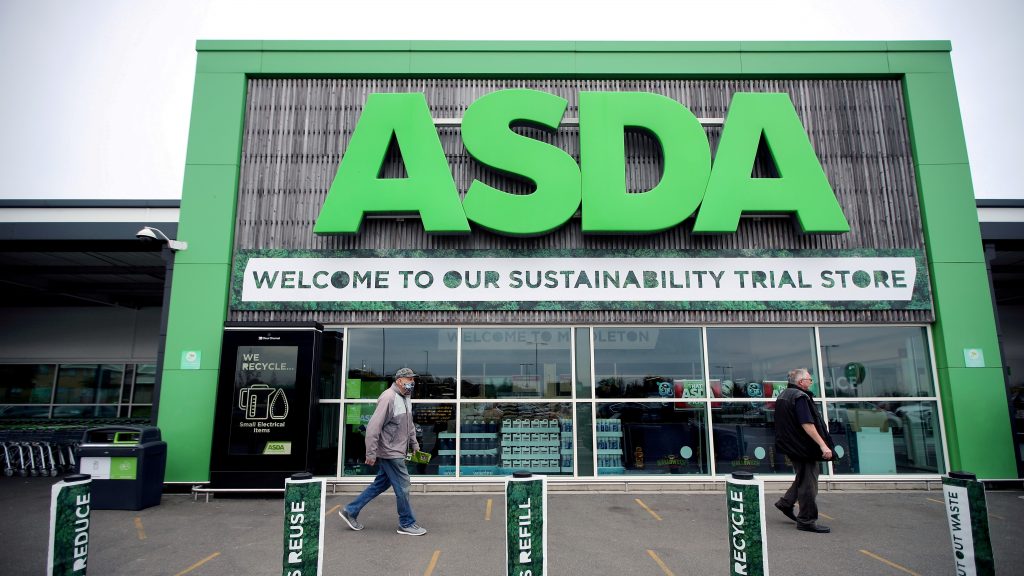 Shoppers walk past the UK supermarket Asda in Leeds