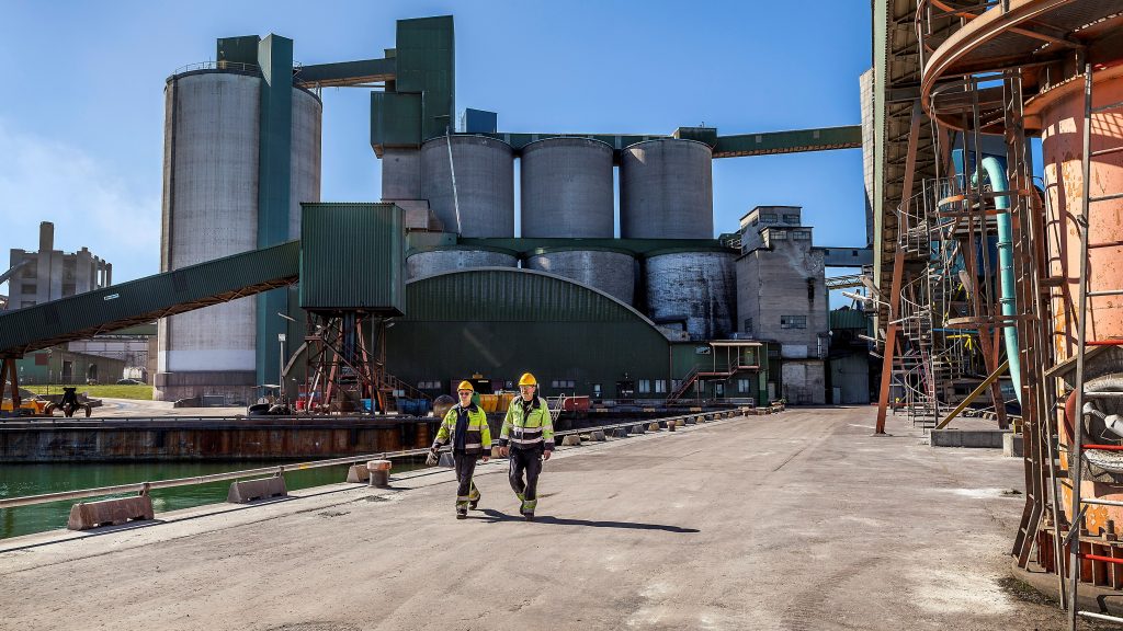 Workers walk at Cementa's Slite plant in Slite