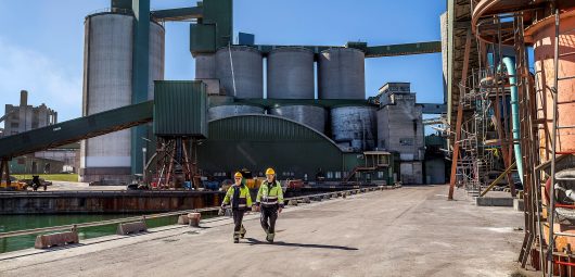 Workers walk at Cementa's Slite plant in Slite