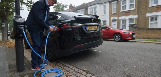 Richard Stobart, CEO of an electric vehicle charging system startup company Char.gy, demonstrates one of the company's lamp post chargers in London